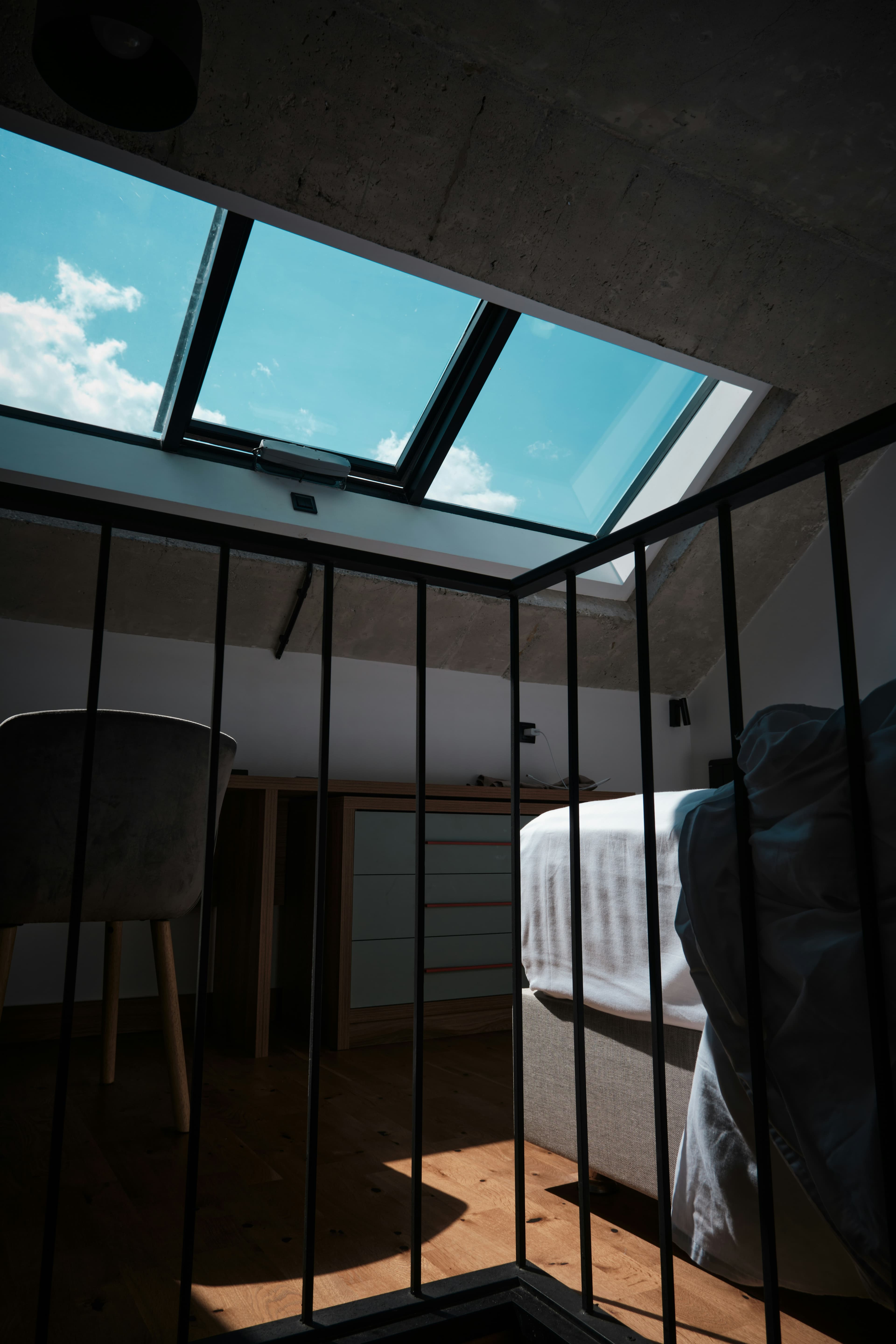 Loft room with a large roof window looking out to the sky