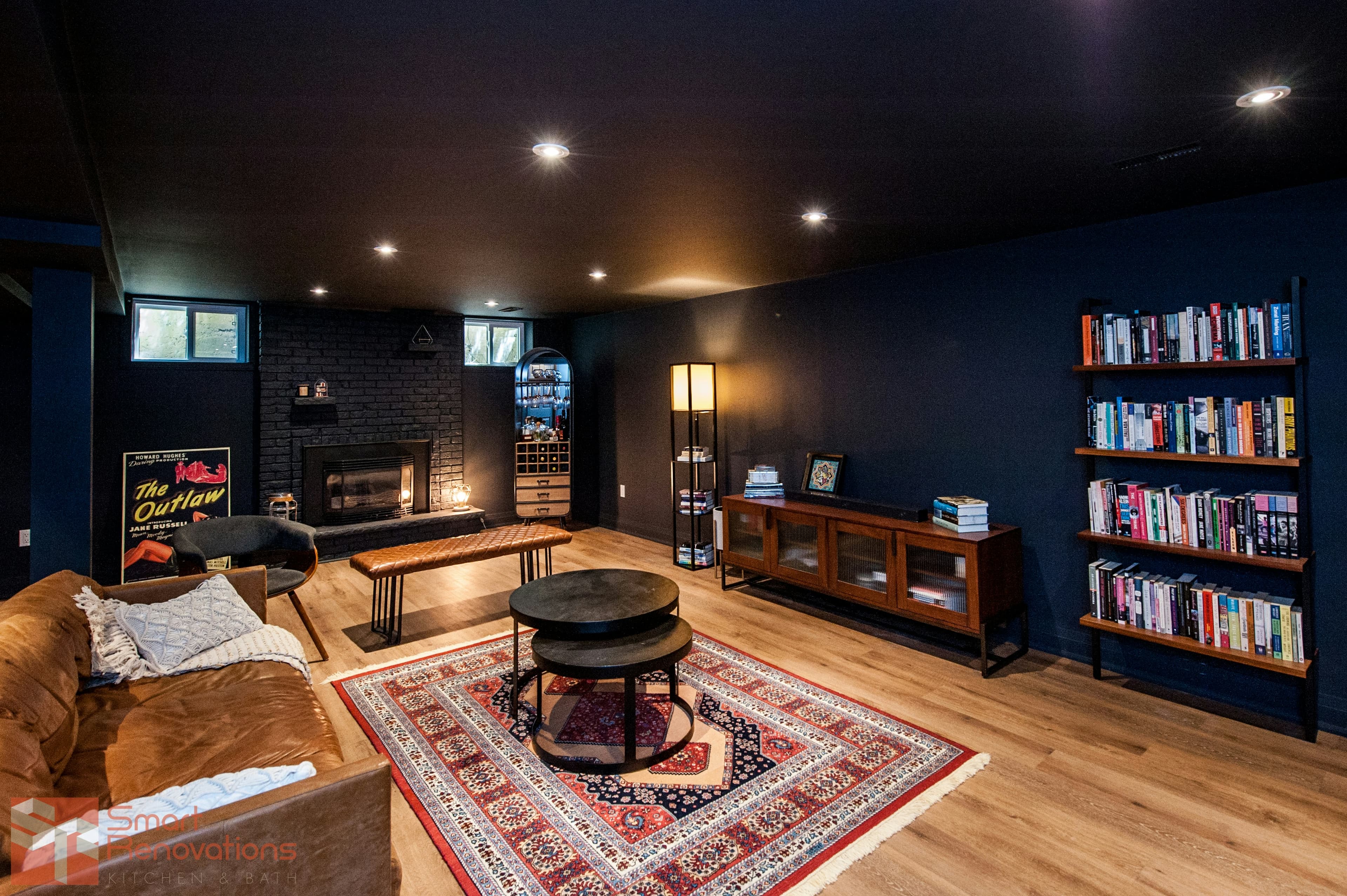 Finished basement room with white walls and wood flooring